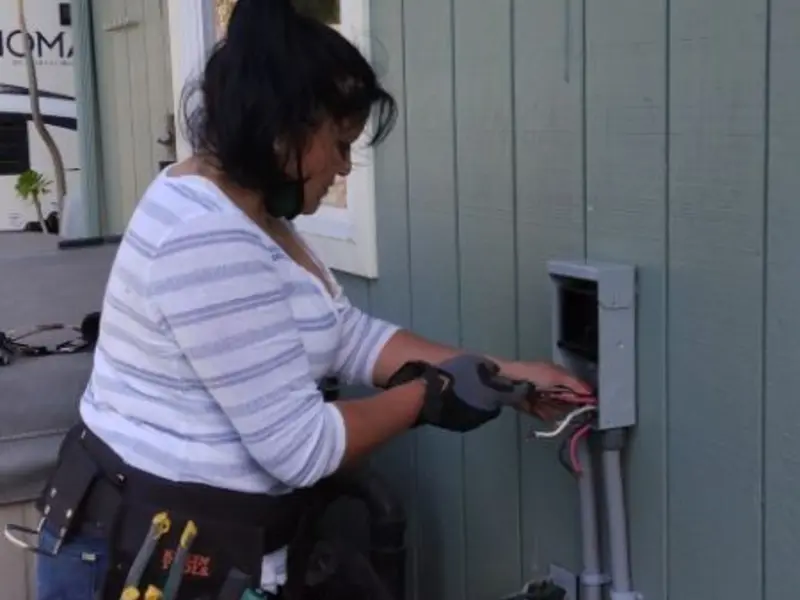 Licensed electrician wiring an exterior subpanel in Avenal